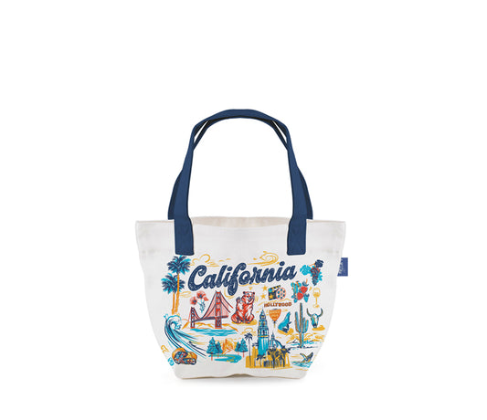 A white canvas tote bag with navy blue handles and a colorful 'California' graphic print on the front, set against a plain white background.