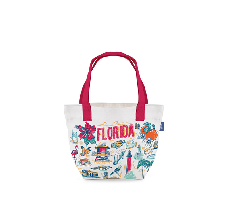 A white canvas tote bag with bright pink handles and a colorful 'Florida' themed illustration print on the front, shown against a plain white background.