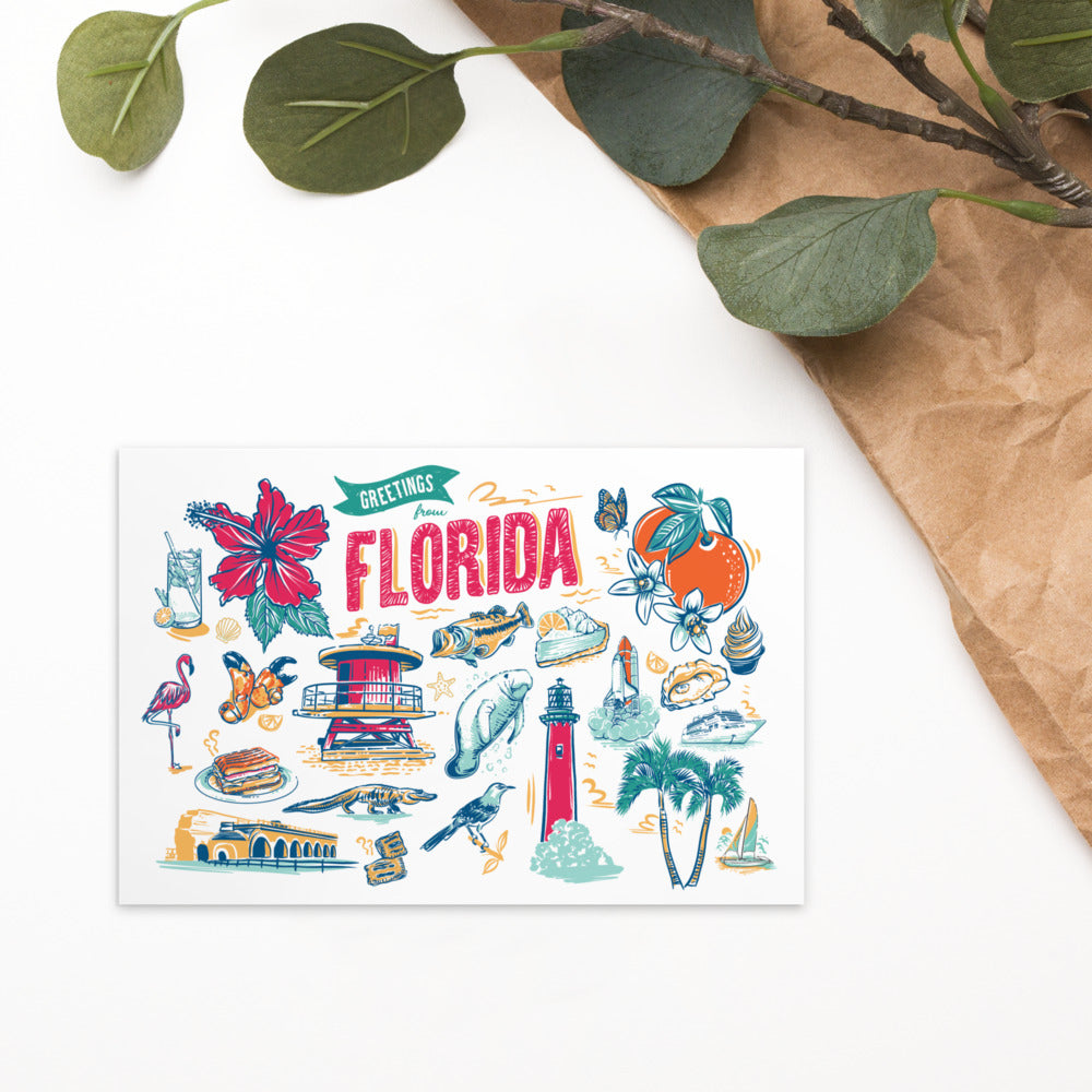 A square greeting card with a colorful hand-drawn Florida collage, styled on a white surface with brown paper and green leaves in the corner.